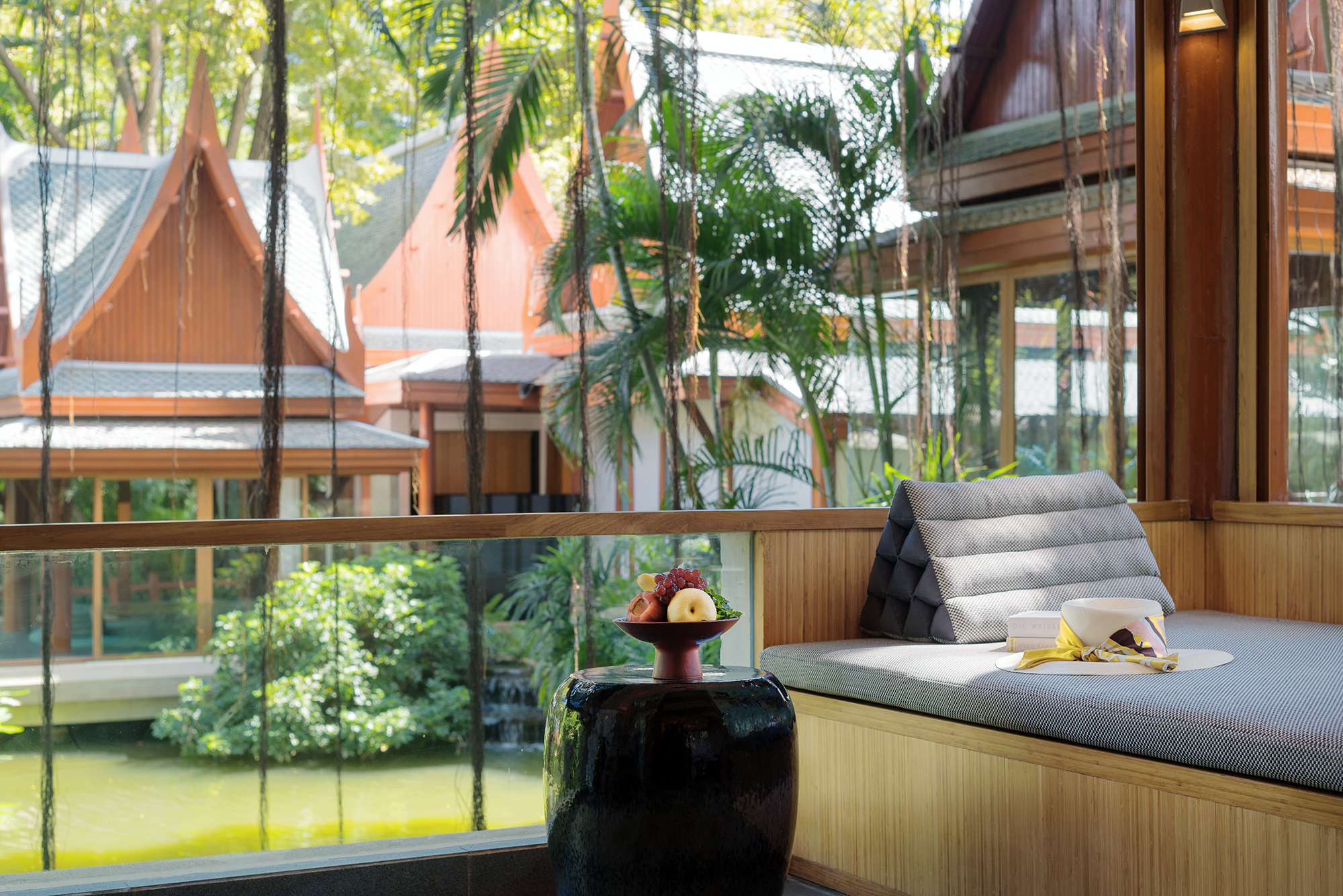 Stylish resort accommodation featuring a cosy bedroom with a spacious bed, and views of lush greenery.